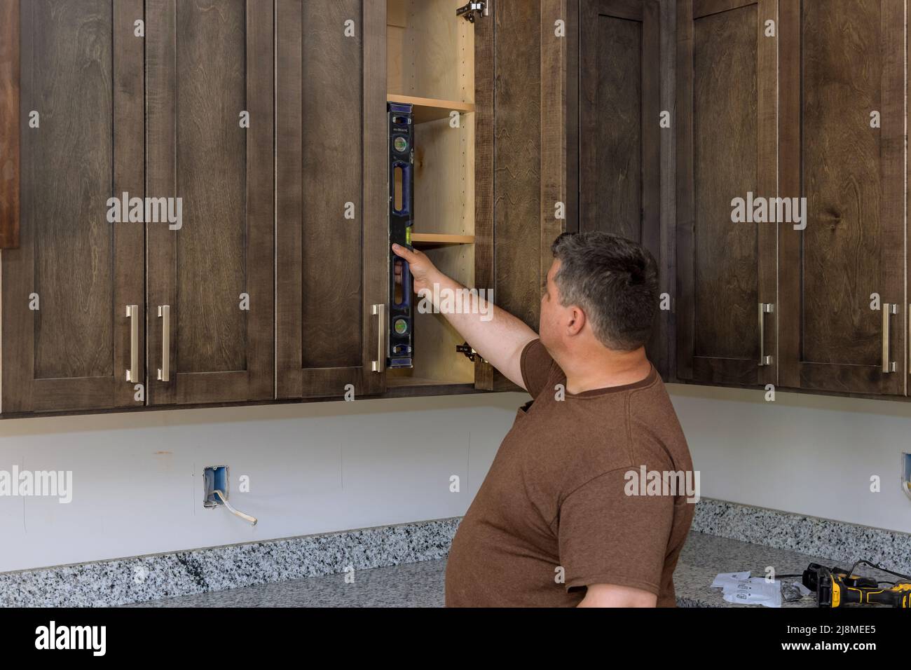 Carpenter at checks level correctness installation custom kitchen