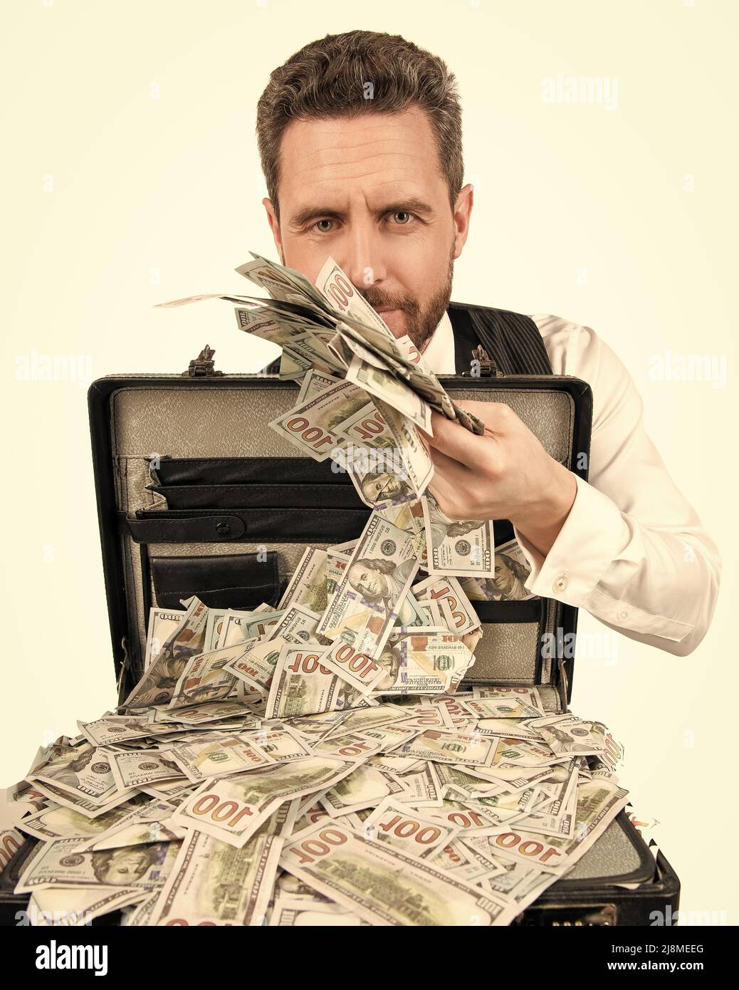 rich millionaire holding case full of dollar cash isolated on white background, bribe Stock Photo