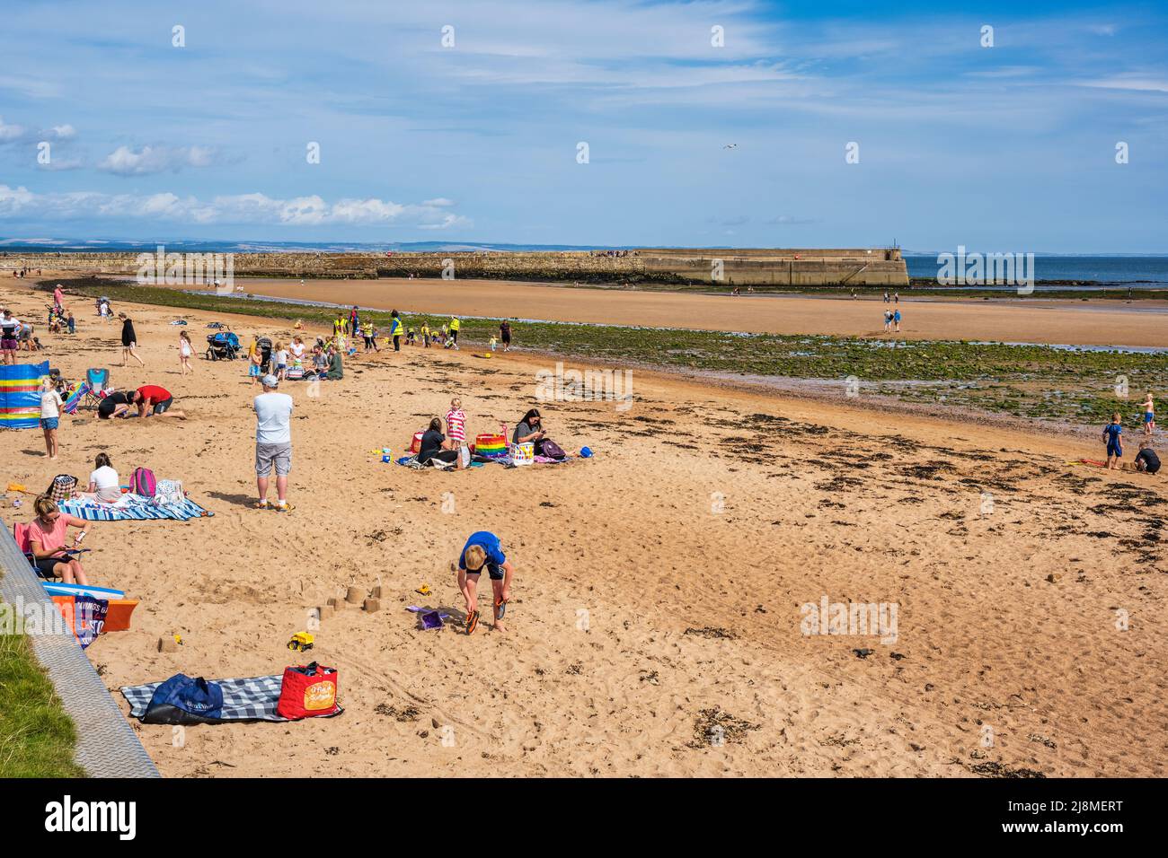 Holidaymakers enjoying the sunshine on East Sands beach in the Royal ...