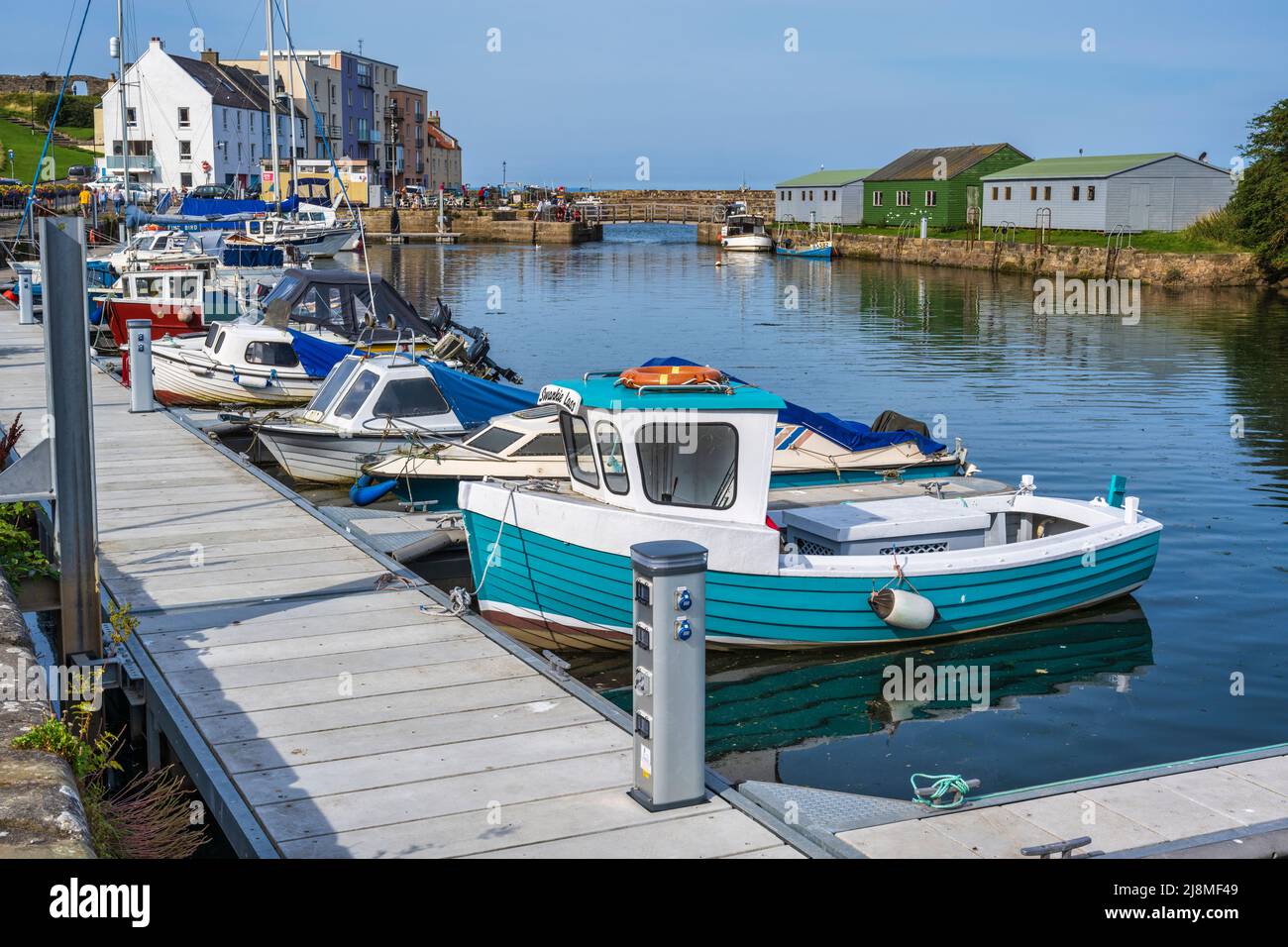 Colourful boats and yachts tied up at pontoon on Kinness Burn at St Andrews harbour in the Royal Burgh of St Andrews in Fife, Scotland, UK Stock Photo