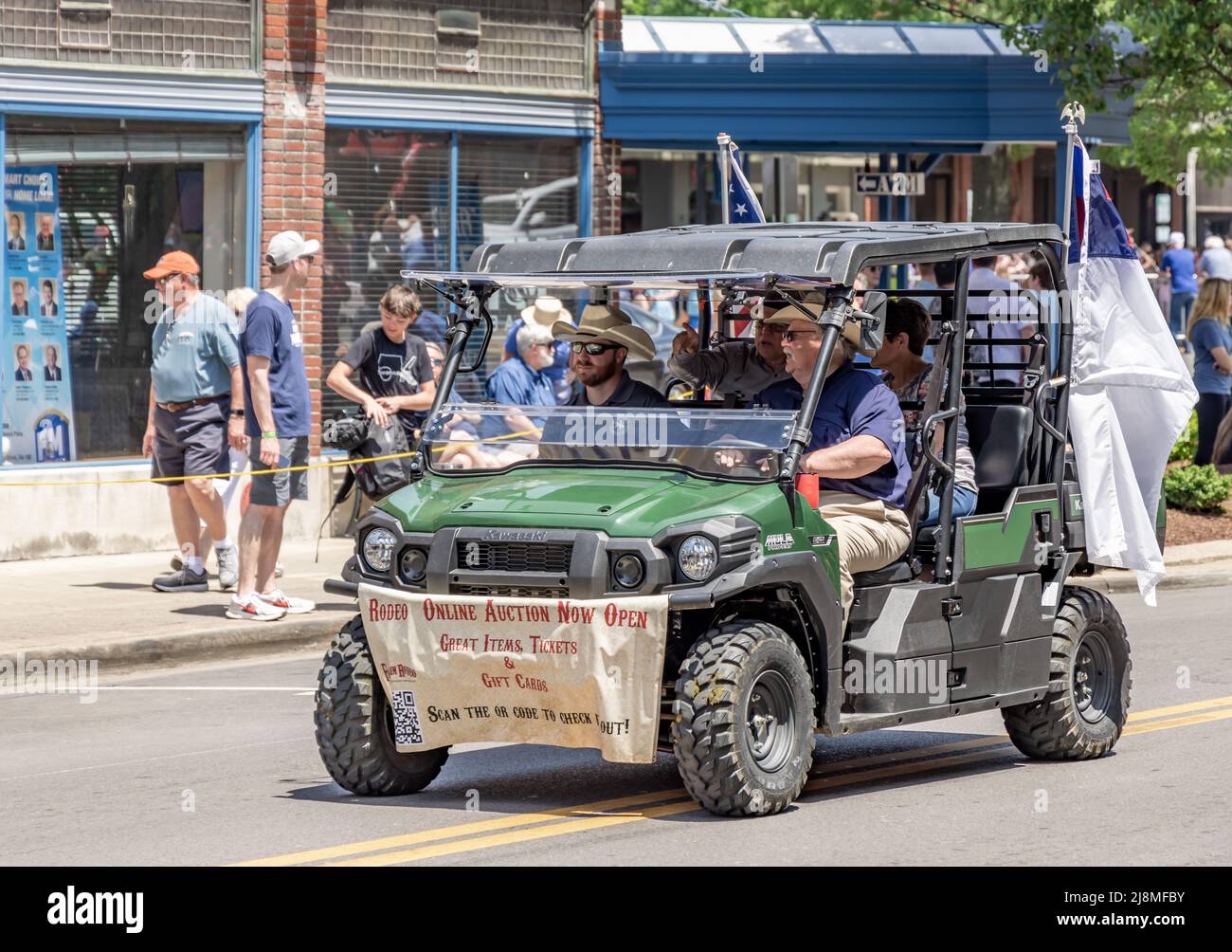 People riding in a four person ATV in the Franklin Rodeo parade Stock Photo