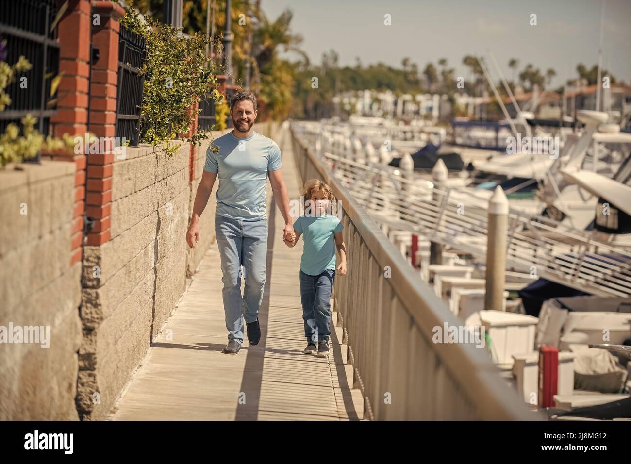 happy single daddy leading small son outside, fathering Stock Photo