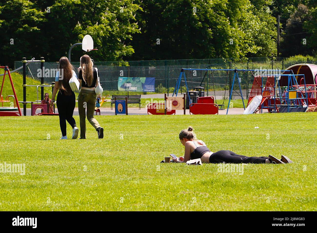 Tenterden, Kent, UK. 17 May, 2022. UK Weather: Sunny afternoon in the Kent town of Tenterden as temperatures are expected to reach the mid twenties. Sunbather enjoys the hot weather in the park. Photo Credit: Paul Lawrenson /Alamy Live News Stock Photo
