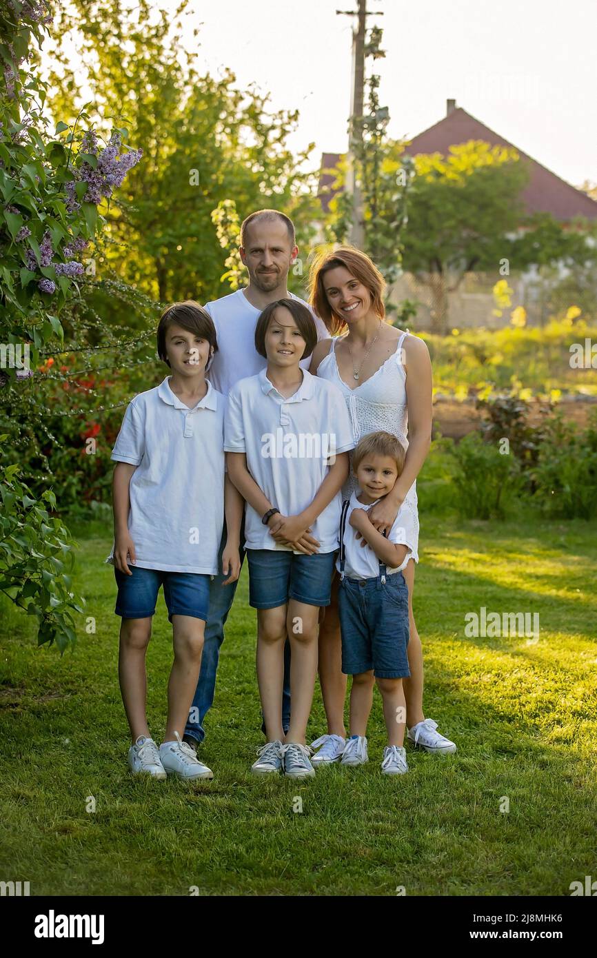 Beautiful family with kids, mom, dad, three boys and a dog, playing in ...