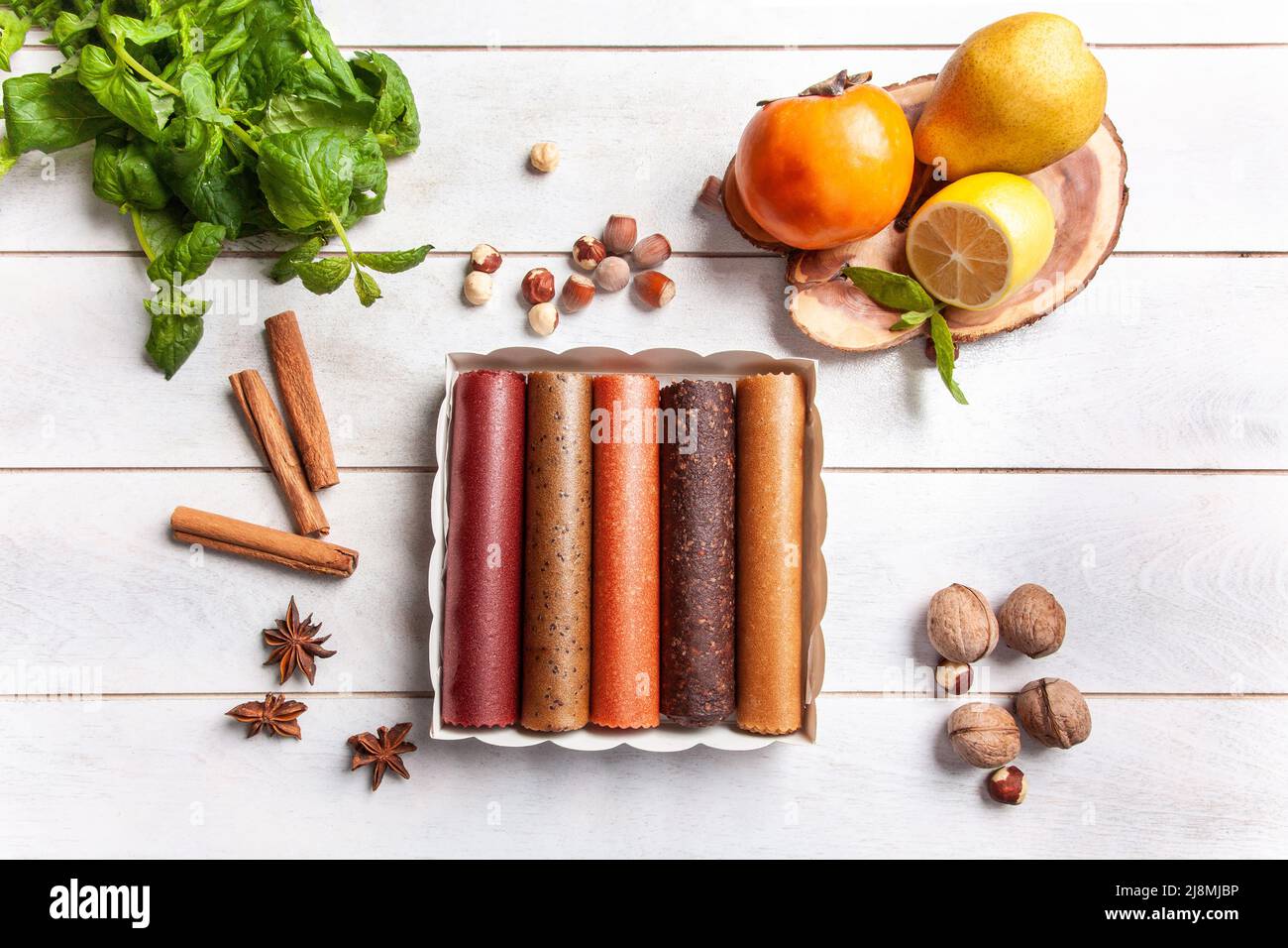 Fruit pastille of different flavors in a gift box surrounded by fresh