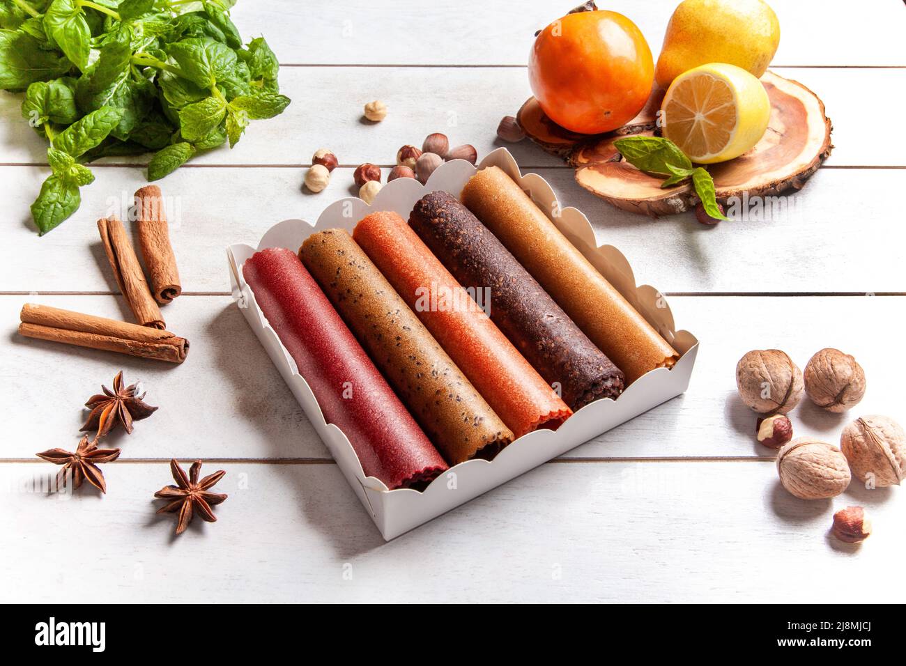 Fruit pastille of different flavors in a gift box surrounded by fresh