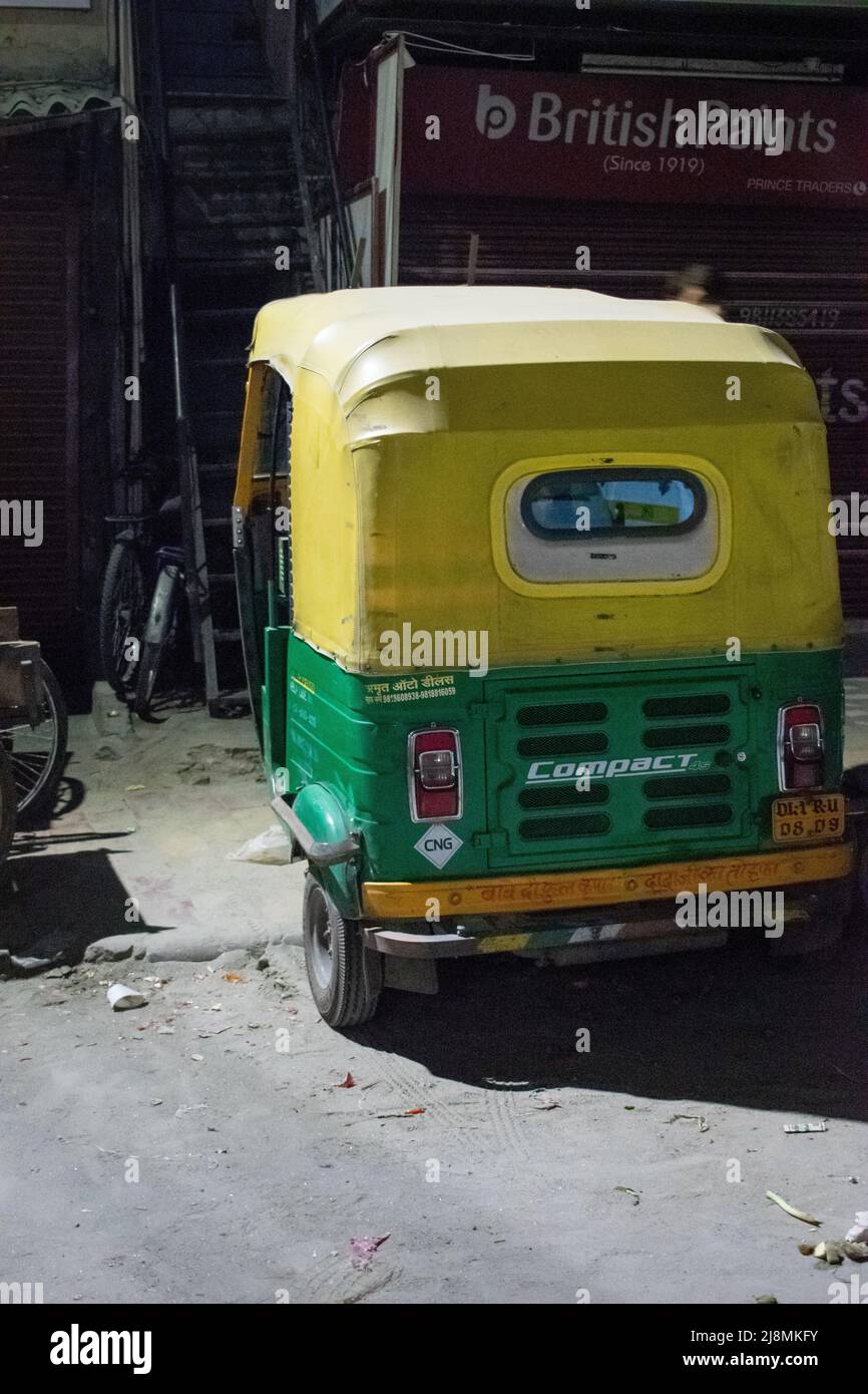 An old auto rickshaw in the night on street. Stock Photo