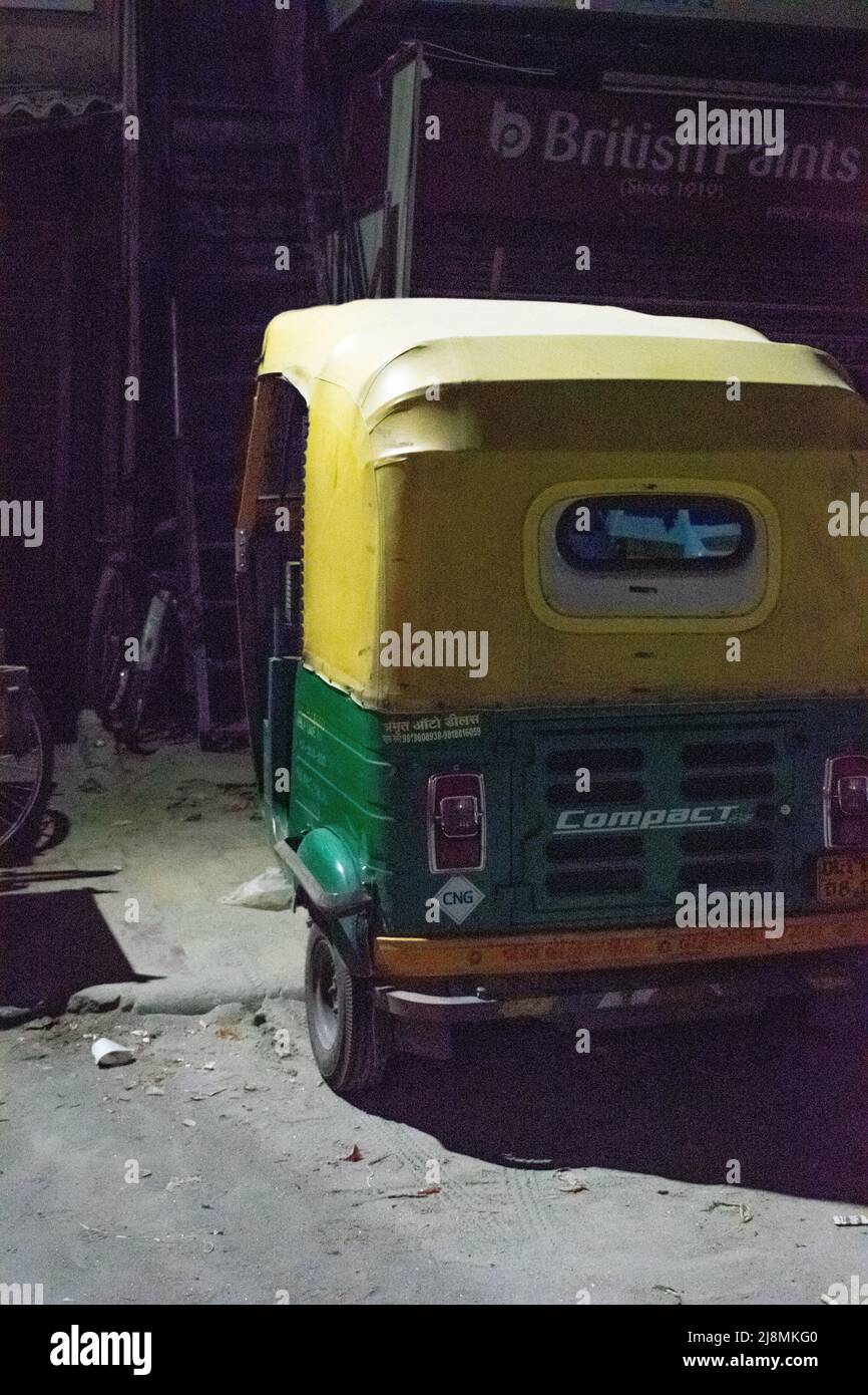 An old auto rickshaw in the night on street. Stock Photo