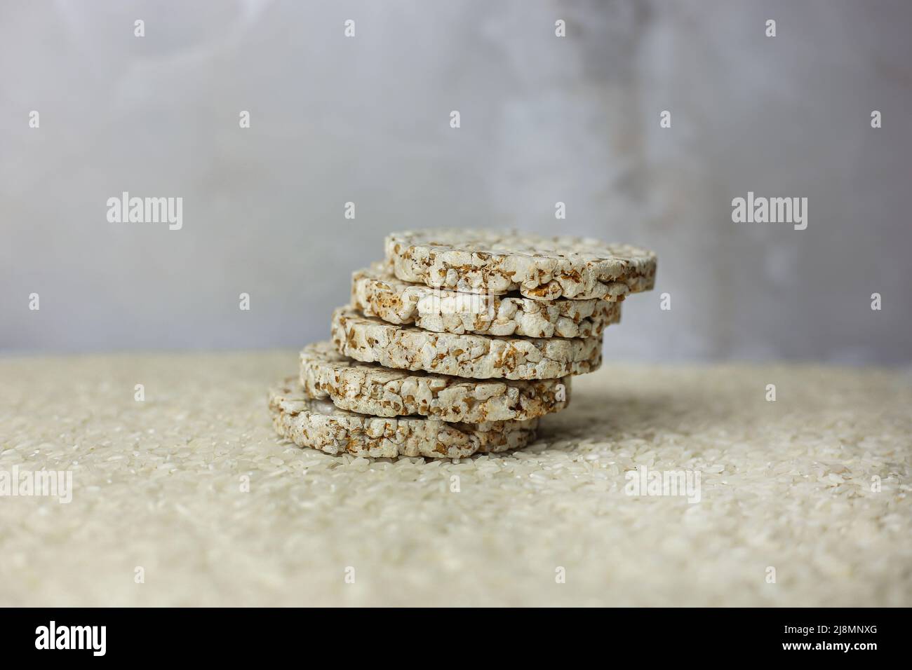 Rice buckwheat cake on a background of strewn rice groats Stock Photo