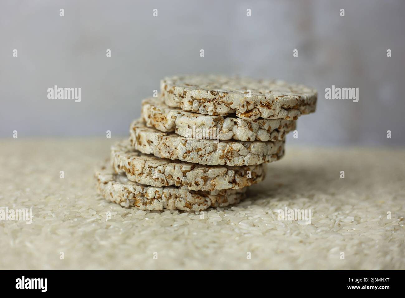 Rice buckwheat cake on a background of strewn rice groats Stock Photo