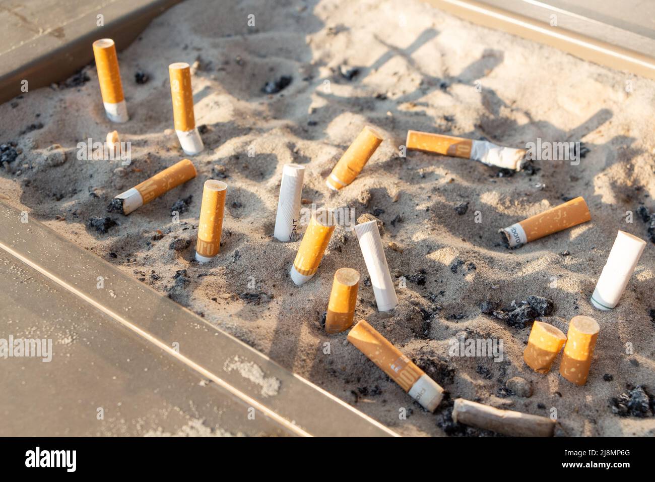 Paris – France, August 19,2018 : Cigarette butts in an ashtray with sand Stock Photo