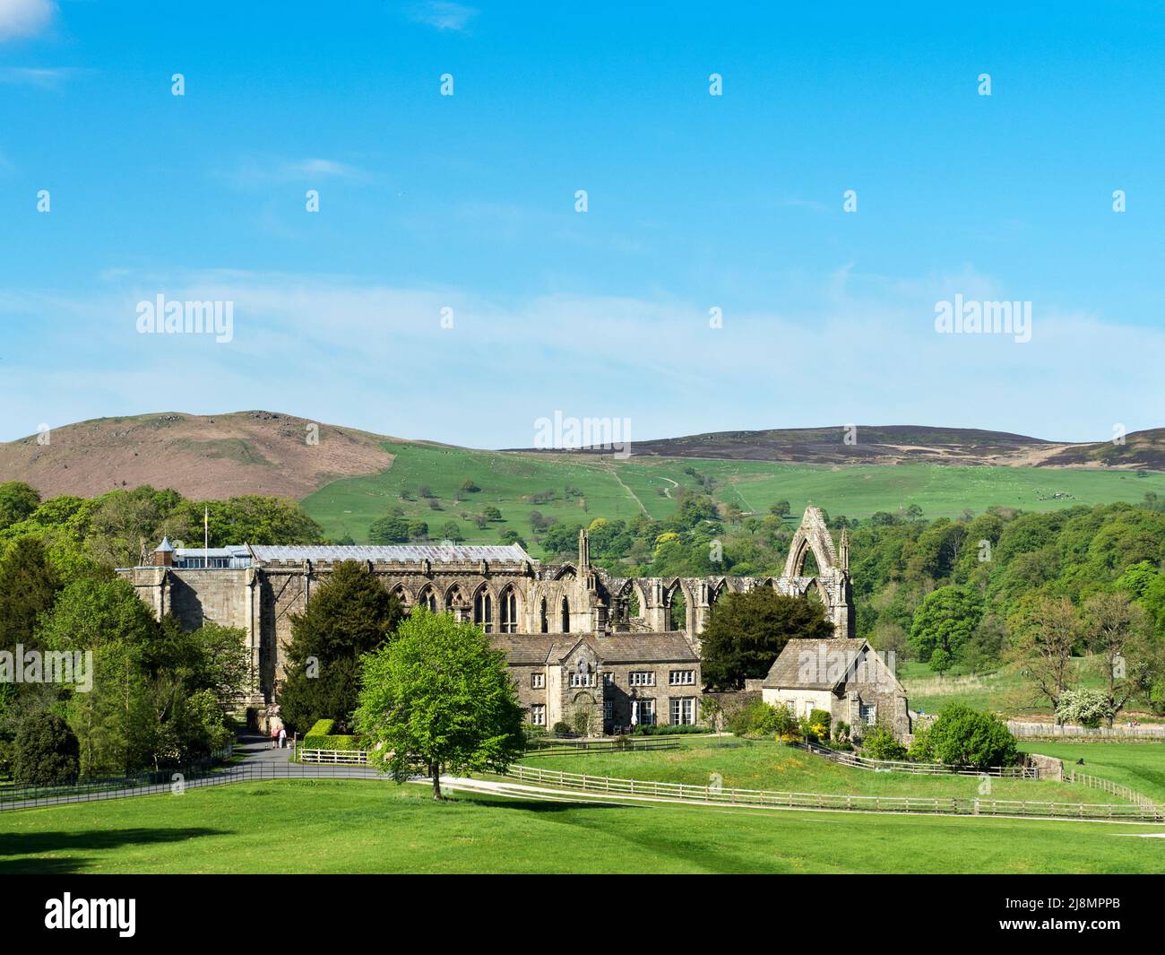 The ruins of Bolton Priory set in the valley by the River Wharfe at Bolton Abbey North Yorkshire England Stock Photo