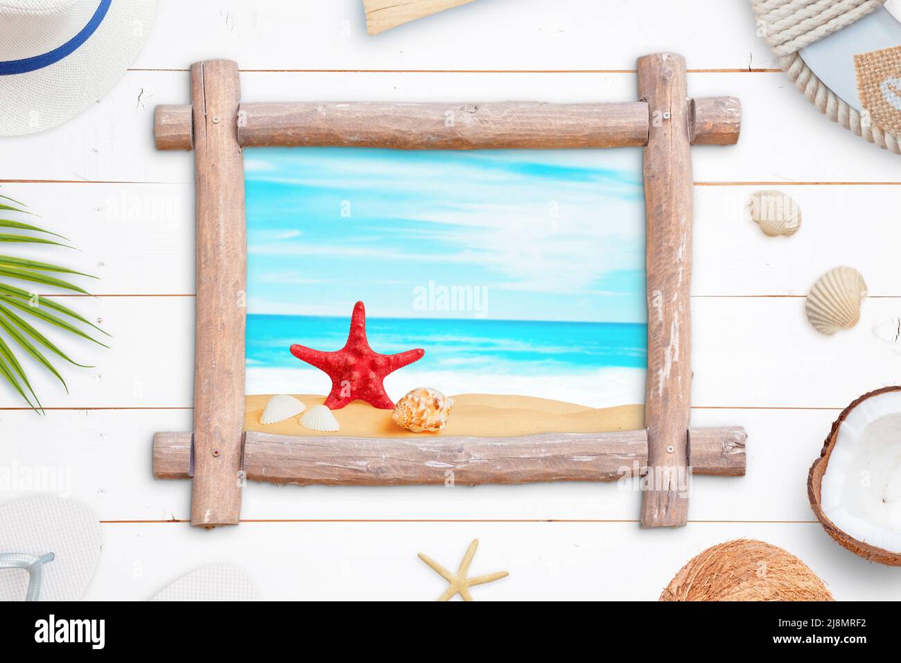Tropical beach window like wooden frame surrounded by summer vacation accessories Stock Photo