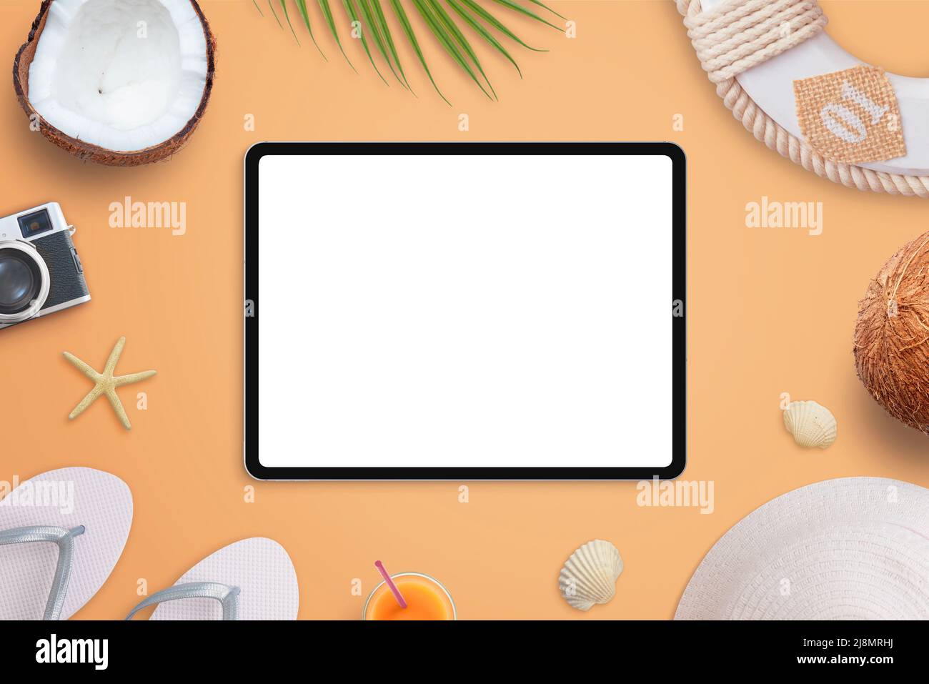 Tablet mockup on beach concept. Isolated screen for design promotion. Top view, flat lay composition with traveler accessories Stock Photo