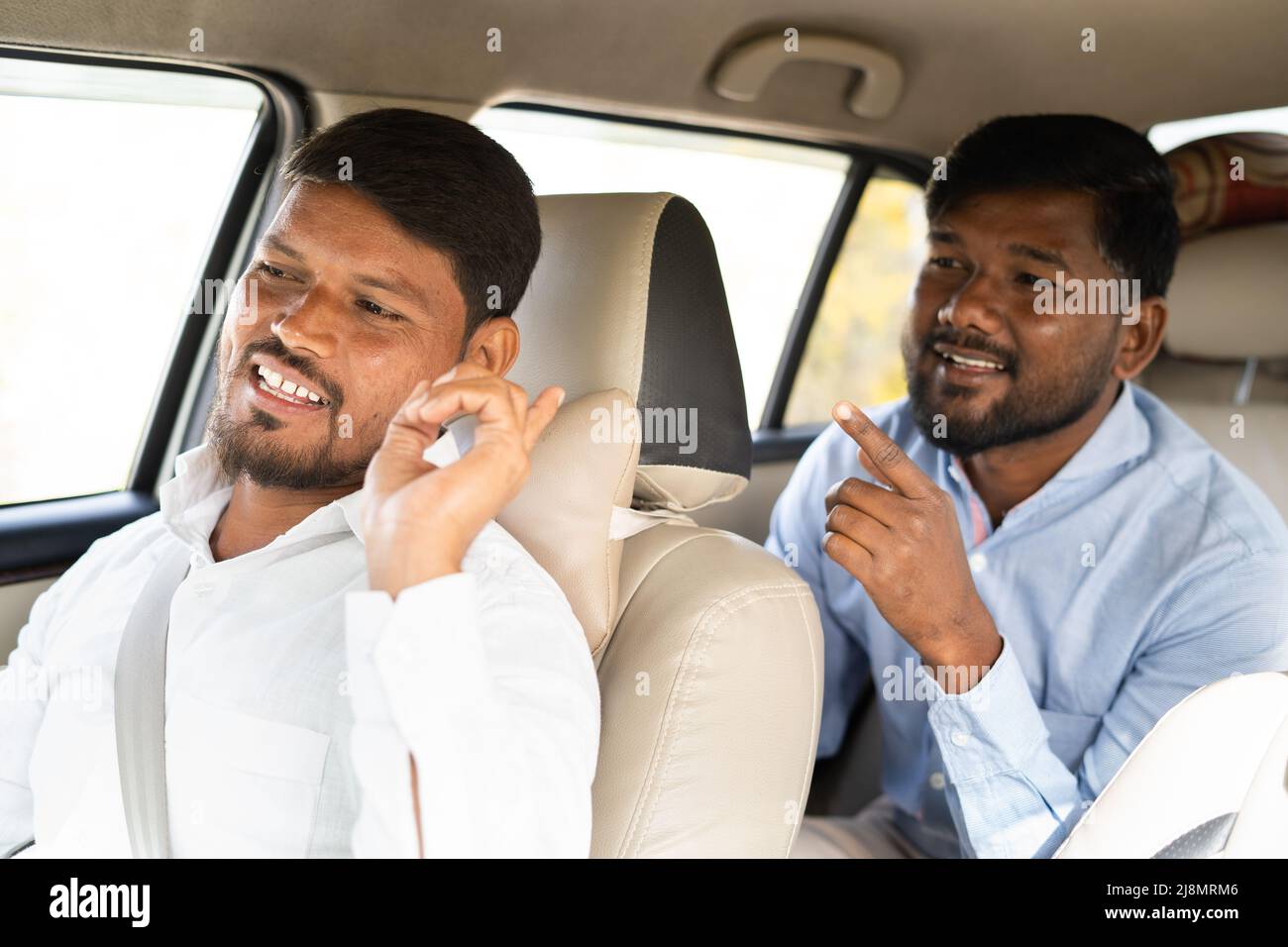 commuter talking to cab driver about location - concept of traveling on taxi, communication, journey and transportation. Stock Photo
