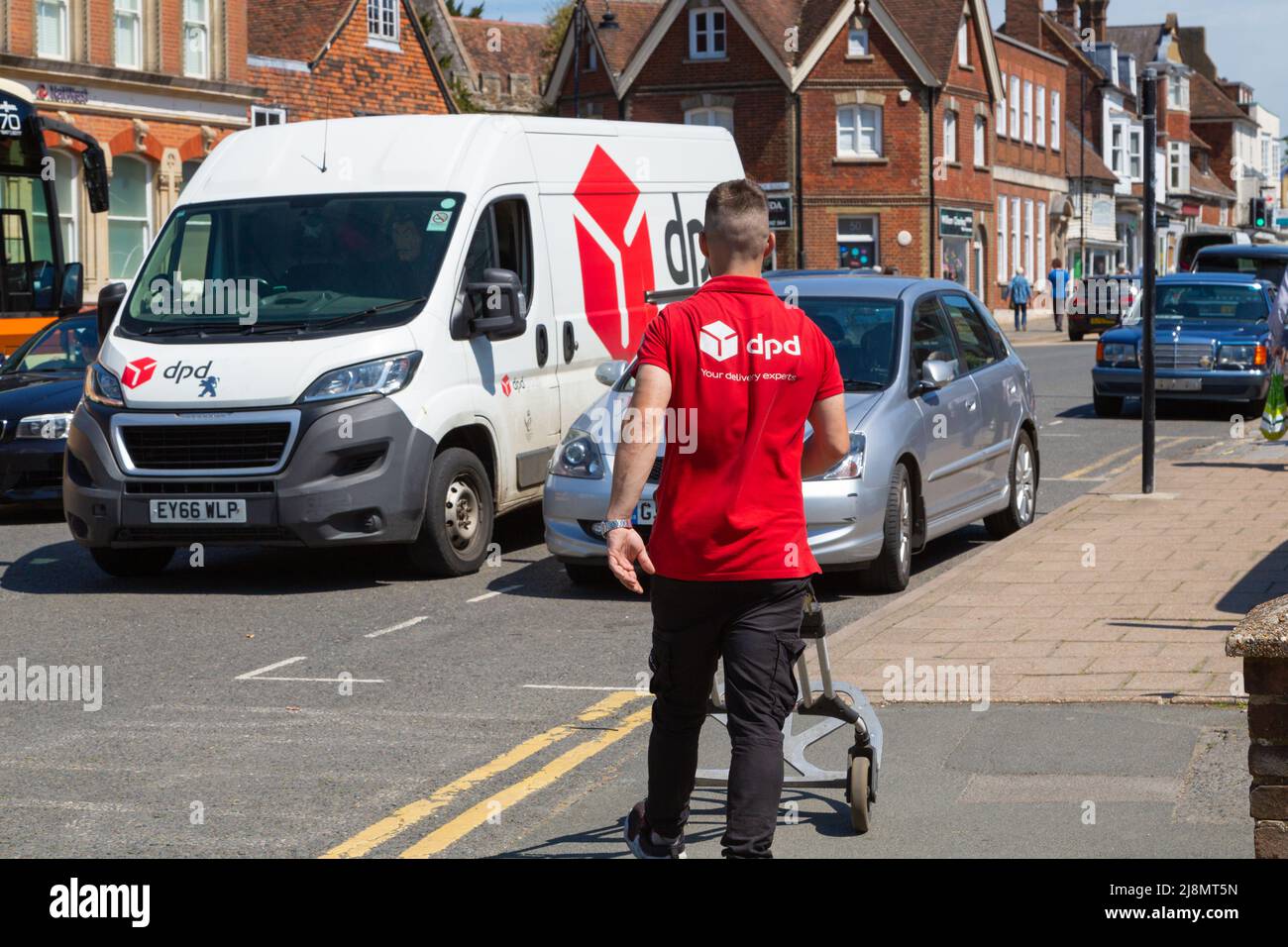 dpd delivery driver and van parked in tenterden high street, kent, uk Stock Photo