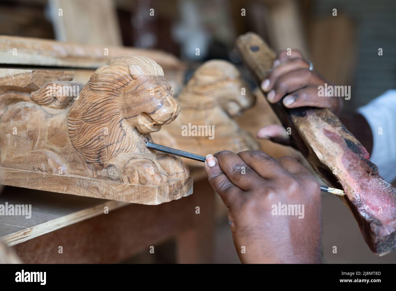 close up shot of carpenter hands busy making wood design or shaping using carpentry tools at shop - concept of creativity, skilled labour and wood Stock Photo