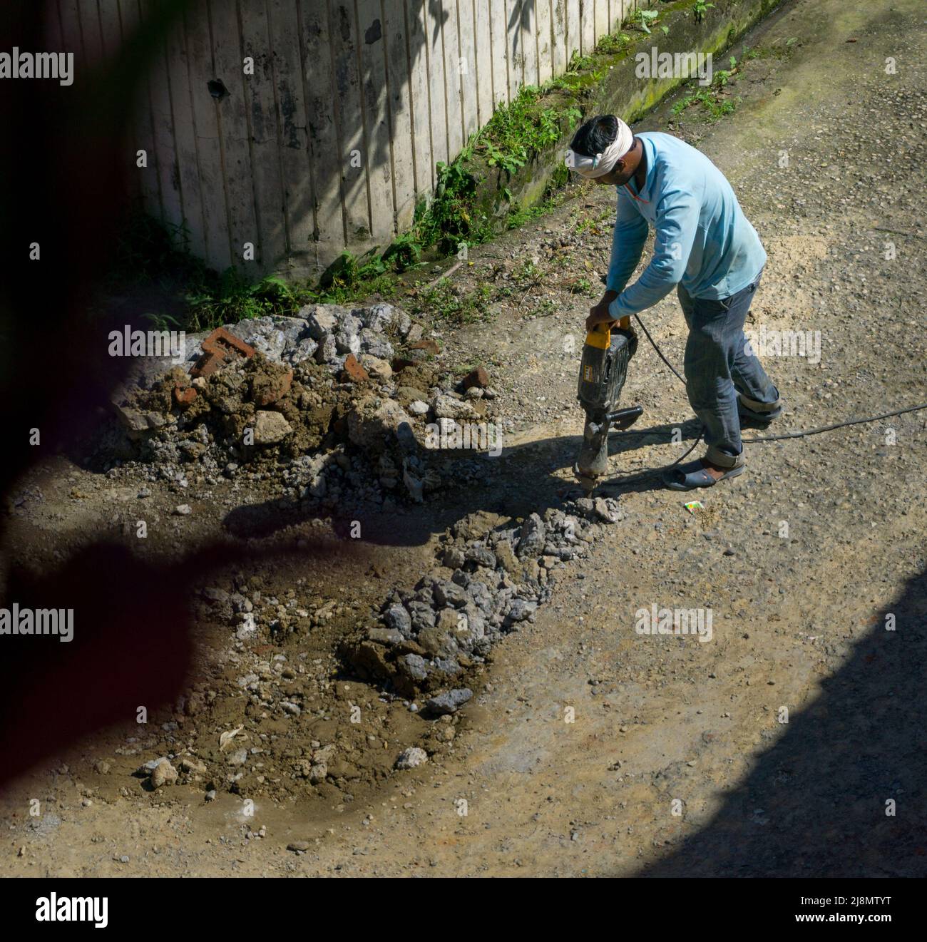 8th August 2020. Uttarakhand India. A construction worker operating hammer drill or jackhammer on a road in India for repair Stock Photo Alamy