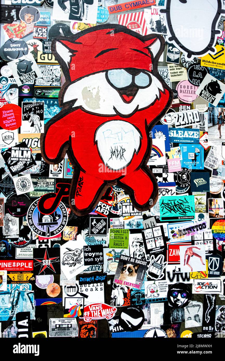Dared Street art paste-up and many stickers on a door in Mitte,Berlin,Germany. Urban art Stock Photo