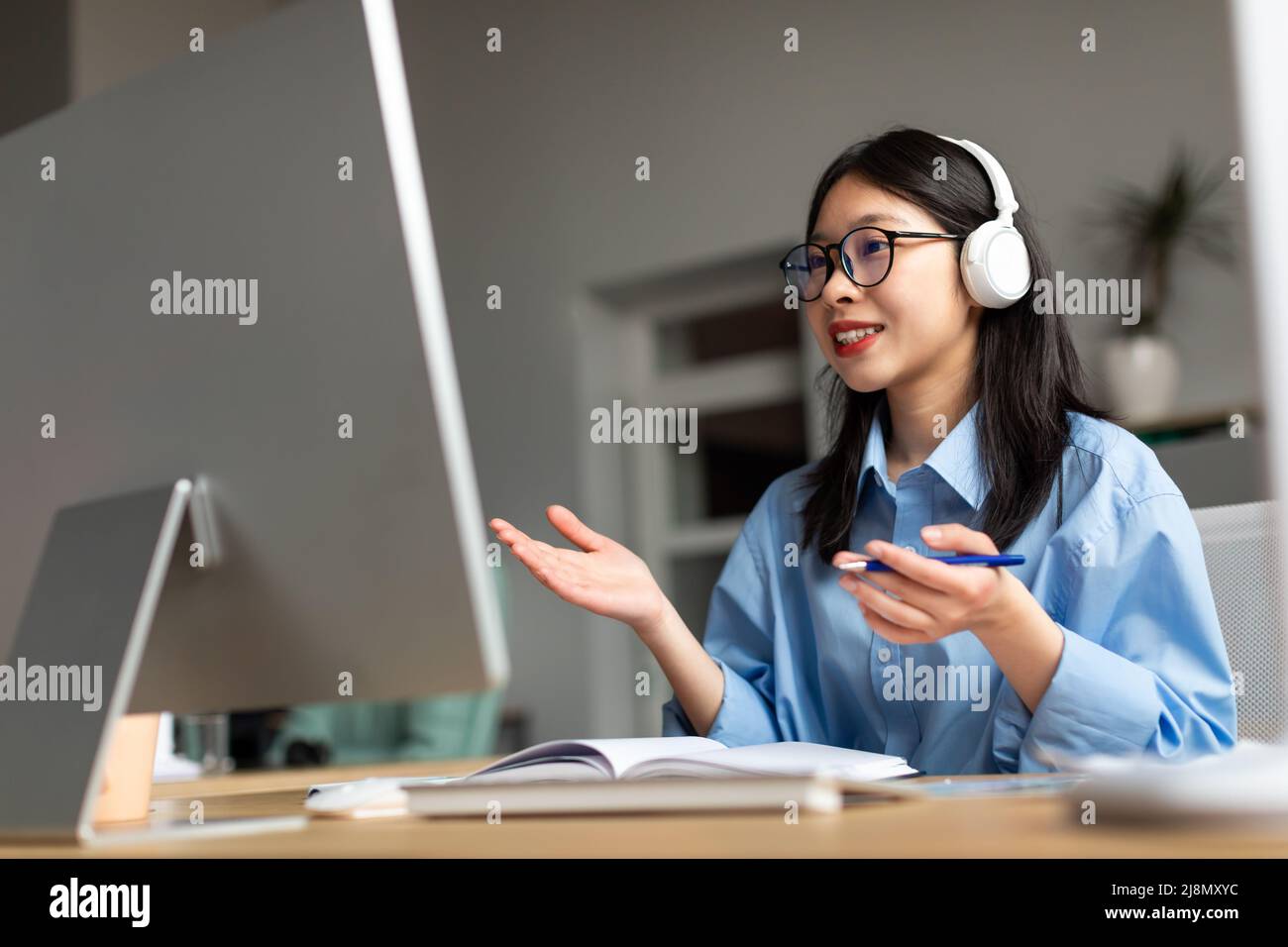 Asian woman having video call using pc and talking Stock Photo - Alamy