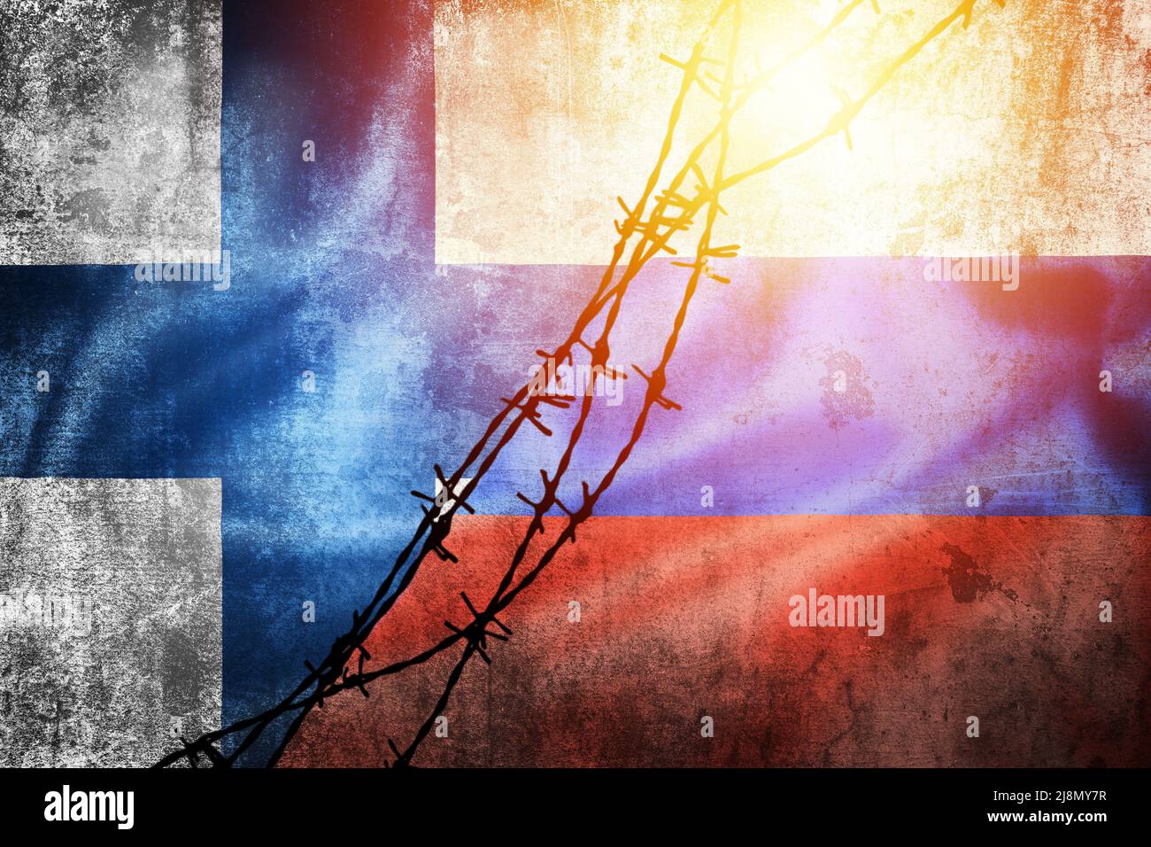 Grunge flags of Russian Federation and Finland divided by barb wire sun haze illustration, concept of tense relations between west and Russia Stock Photo