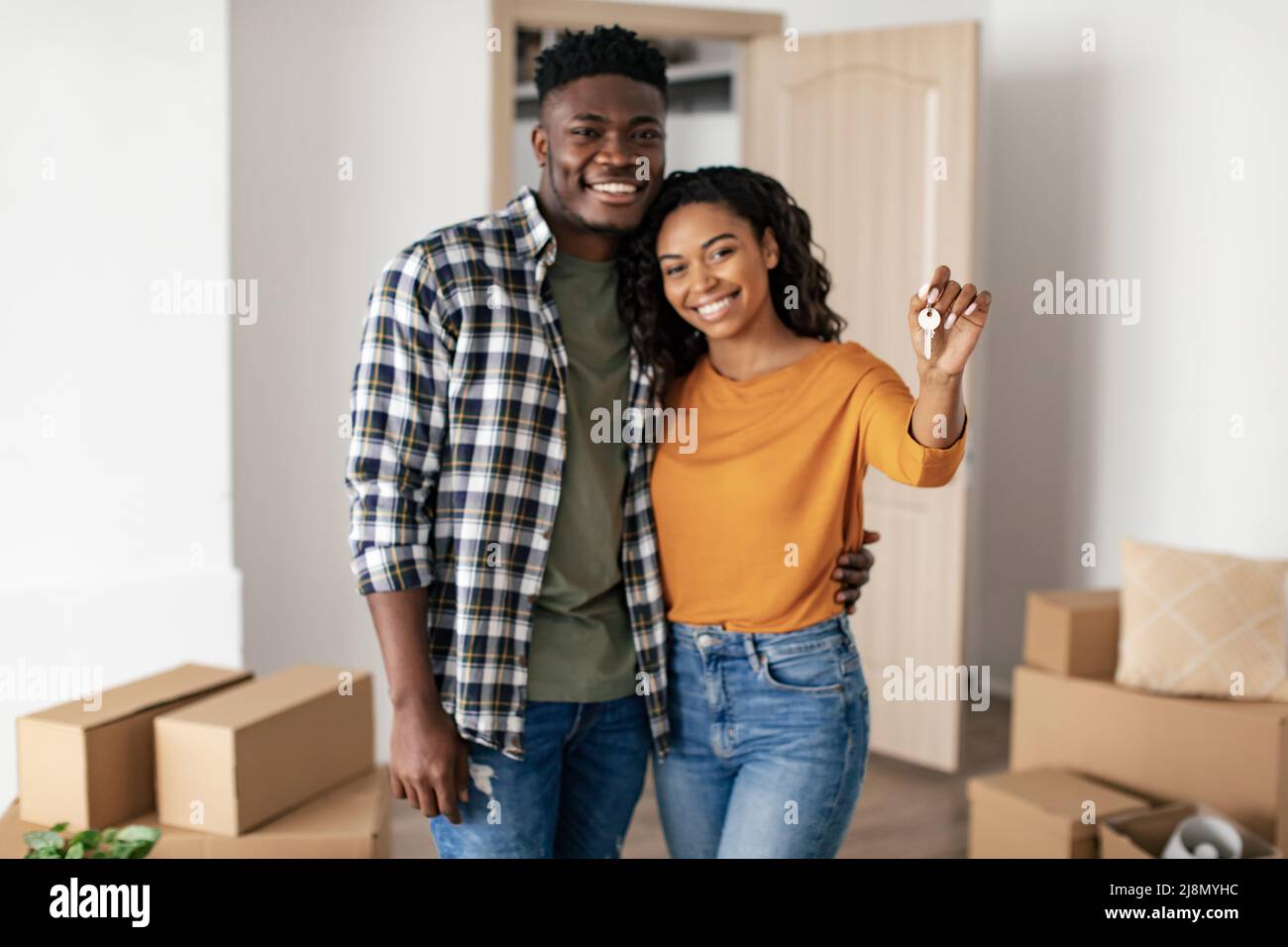 Joyful Black Couple Holding House Key Hugging Moving New Home Stock ...