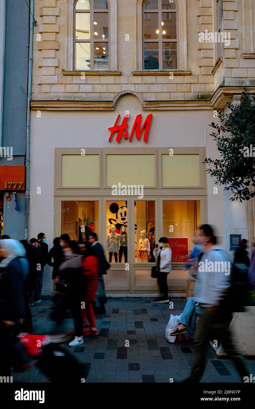 H and M street store and motion blur of the people in Istiklal Avenue or Istiklal Caddesi. vertical photo. Istanbul Turkey - 11.13.2021 Stock Photo
