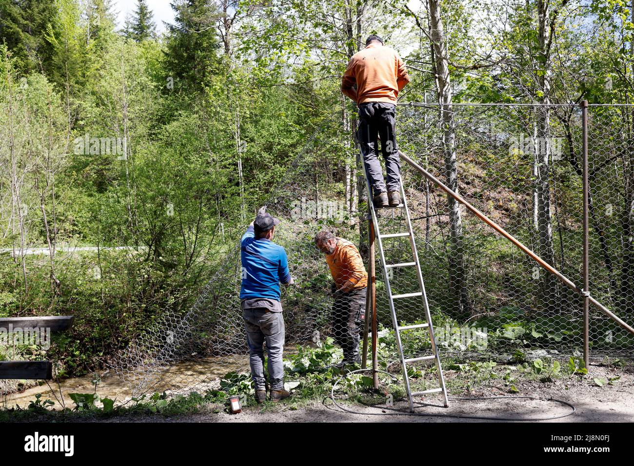 Construction workers build the fence surrounding the hotel Castle Elmau, where the G7 Summit will be held in June 2022, in Kruen near the southern Bavarian resort of Garmisch-Partenkirchen, Germany, May 17, 2022. REUTERS/Michaela Rehle Stock Photo