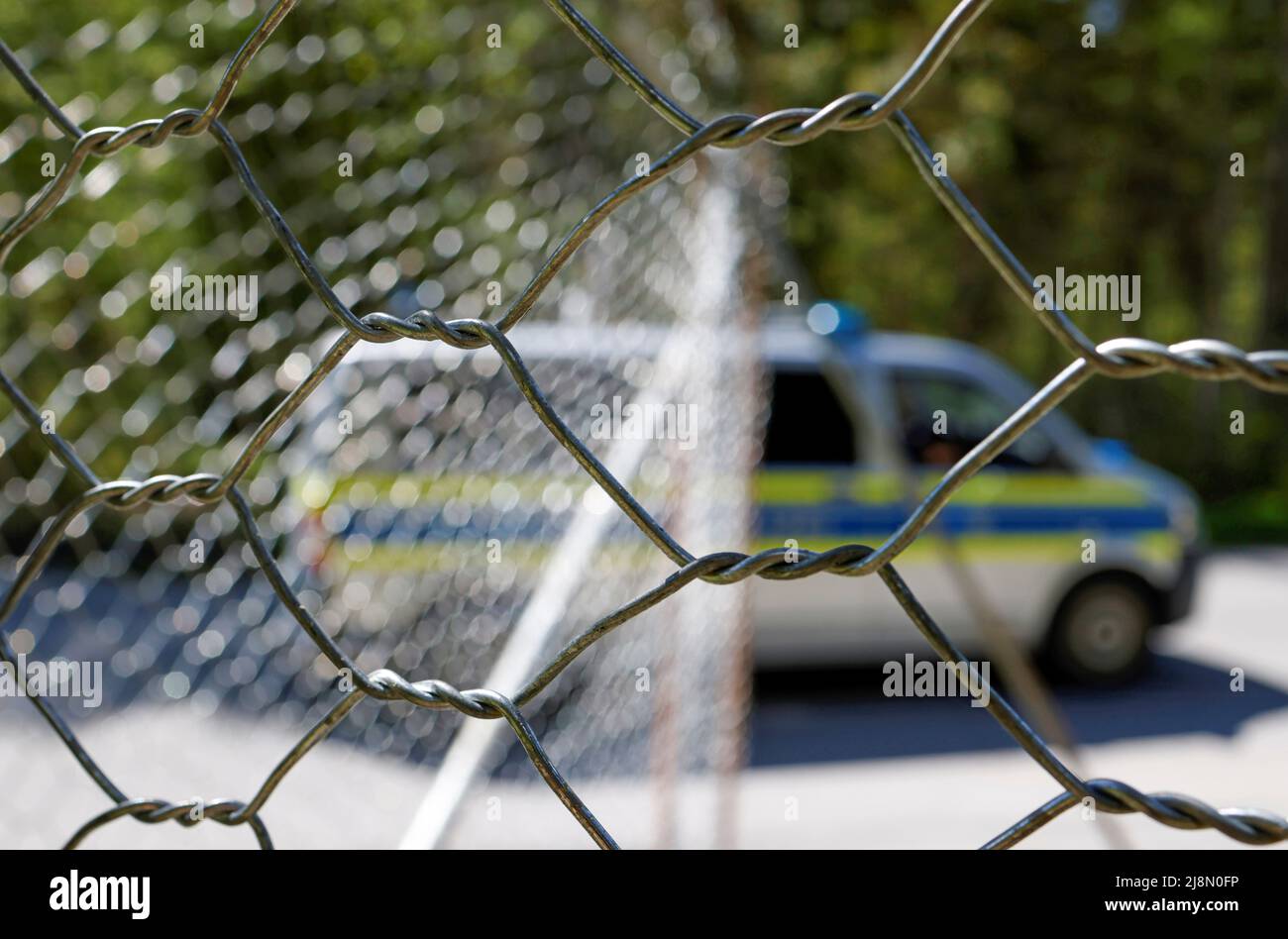 A police car passes the fence surrounding the hotel Castle Elmau, where the G7 Summit will be held in June 2022, in Kruen near the southern Bavarian resort of Garmisch-Partenkirchen, Germany, May 17, 2022. REUTERS/Michaela Rehle Stock Photo