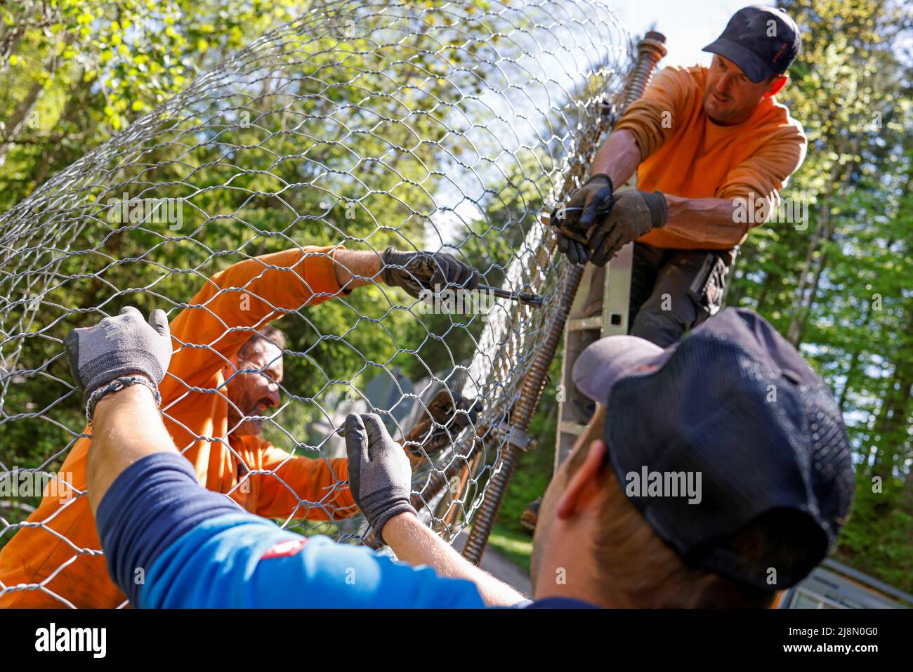Construction workers build the fence surrounding the hotel Castle Elmau, where the G7 Summit will be held in June 2022, in Kruen near the southern Bavarian resort of Garmisch-Partenkirchen, Germany, May 17, 2022. REUTERS/Michaela Rehle Stock Photo