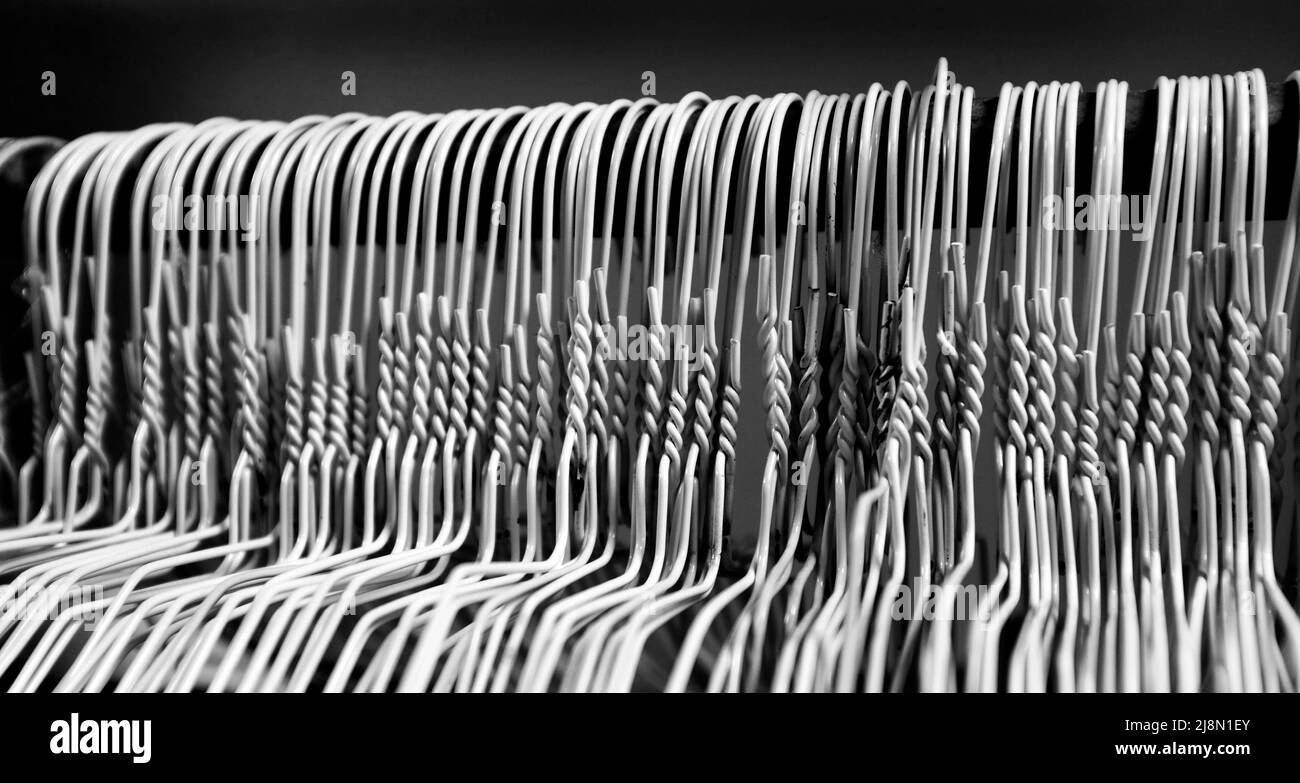 https://c8.alamy.com/comp/2J8N1EY/many-several-metal-wire-hangers-on-pole-for-hanging-clothing-in-closet-storage-2J8N1EY.jpg