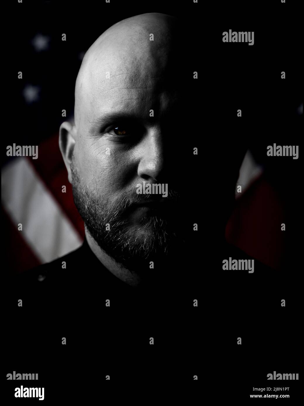 Black and white half shadow portrait with colored flags in the background Stock Photo