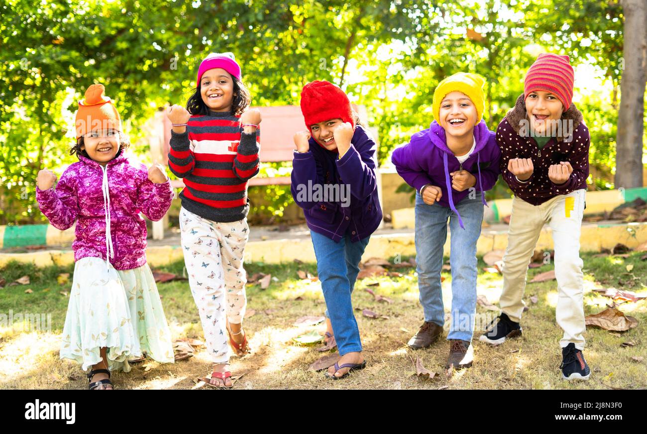 Cheerful Teenager girl kids in warmth winter wear shouting by looking at camera - concept of childhood happiness, positive emotion and outdoor Stock Photo