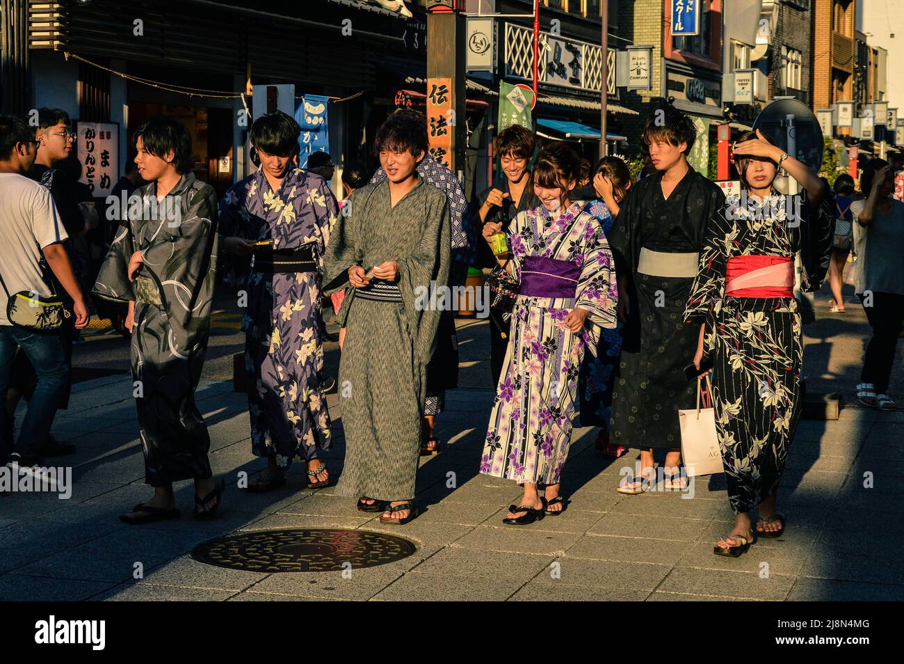 Teenagers dressed in yukata in the streets of Tokyo, Asakusa. Stock Photo