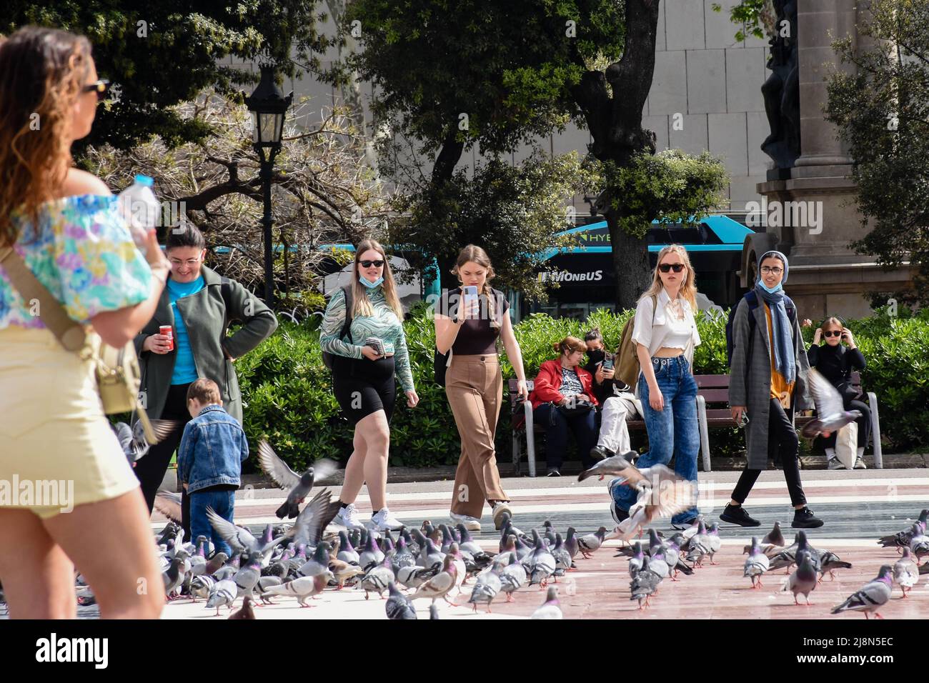 Girls walking across Placa Cataluna in Barcelona while sightseeing Stock Photo