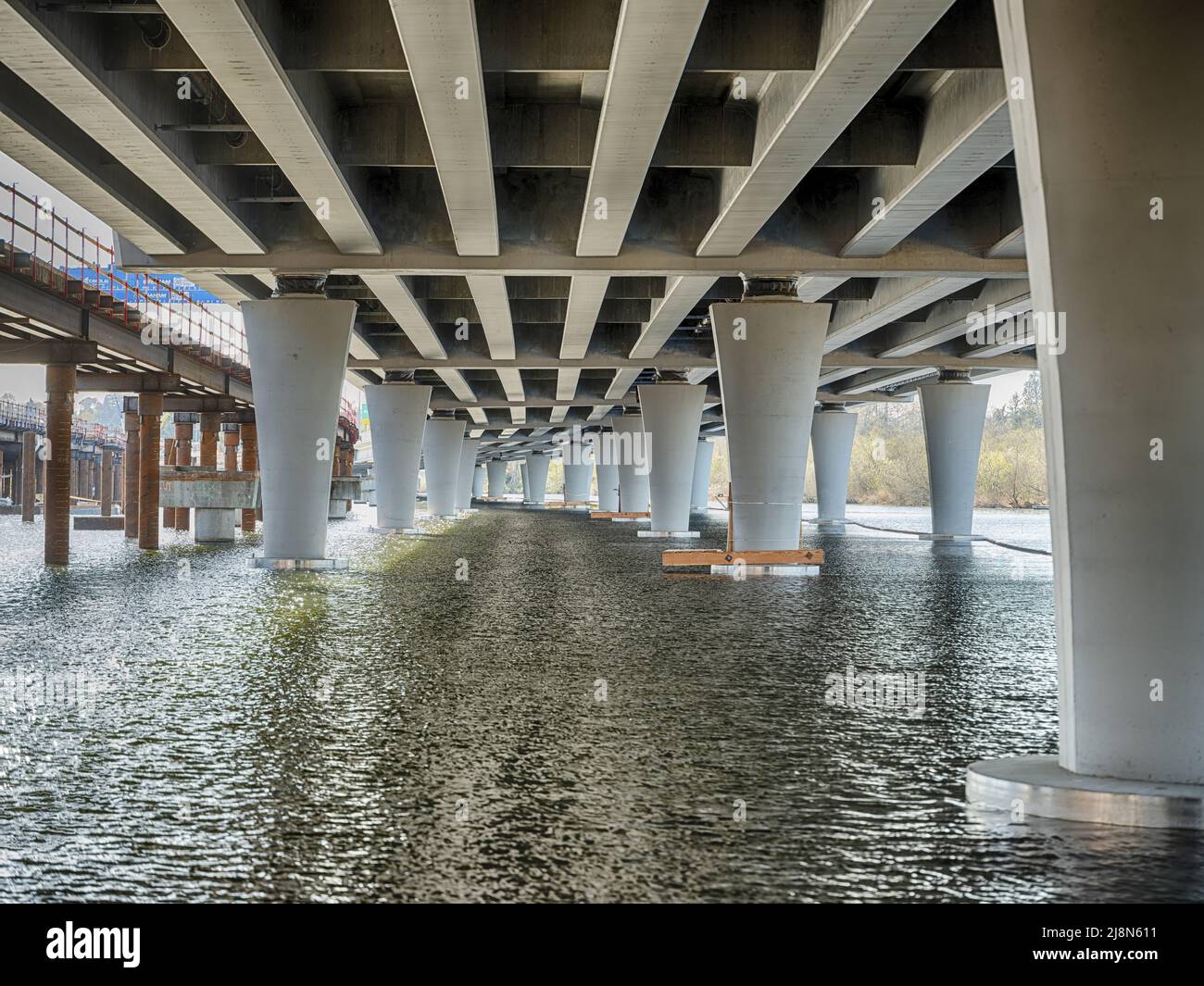 View of a large, multi-lane bridge in Seattle and Lake Washington as seen from underneath Stock Photo