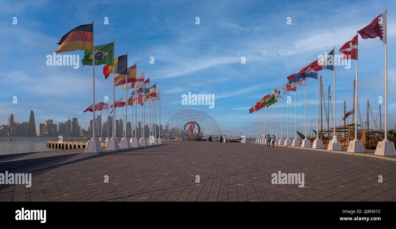 The FIFA World Cup Qatar 2022 Official Countdown Clock  at Doha’s picturesque Corniche Fishing Spot with flags of participating countries Stock Photo