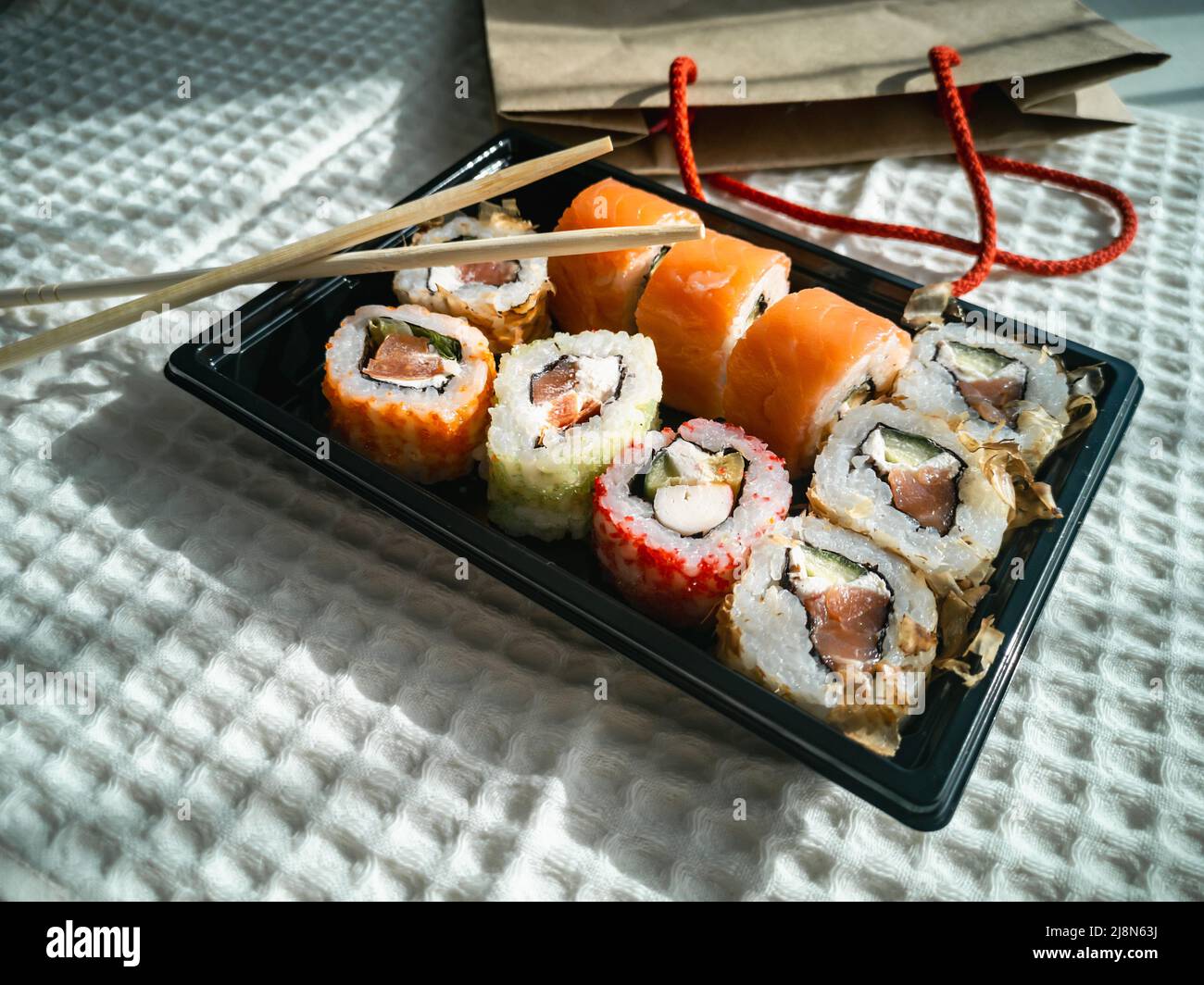 Online ordering and food delivery. Sushi is a Japanese dish Stock Photo