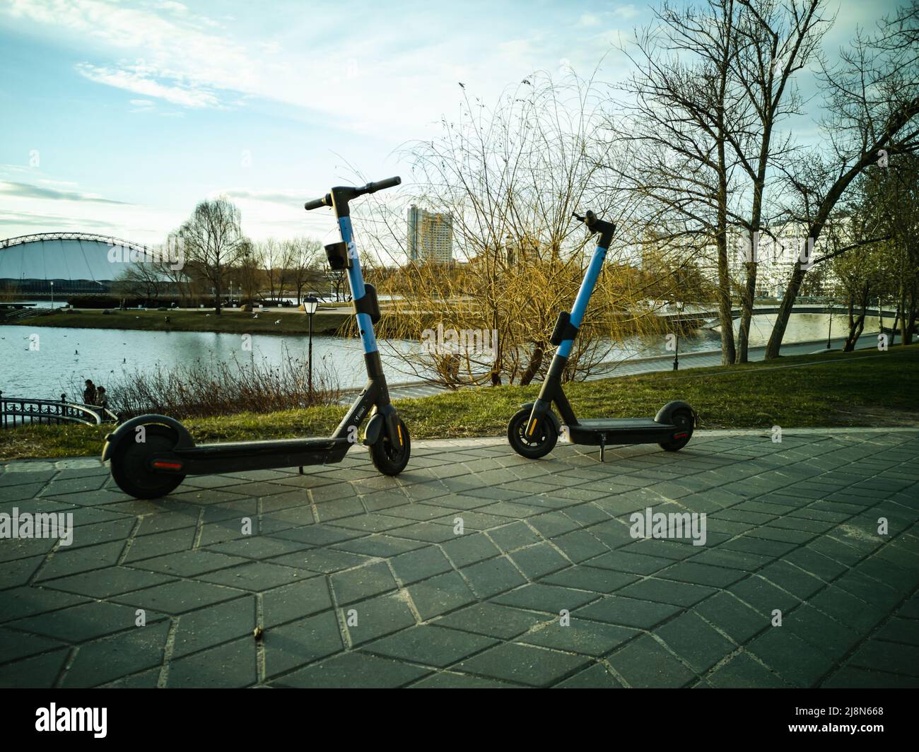 Minsk, Belarus - May 2022: electric scooters for hire in the center of the sity near the river Svisloch. Stock Photo