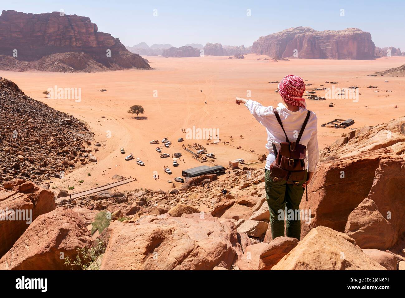 A tourist standing by the look out of a panoramic view of the desert in Wadi Rum, Jordan, Middle East. Stock Photo
