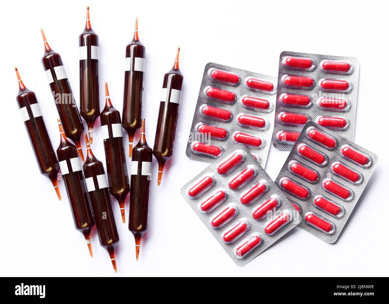 Glass ampoules and capsules containing iron supplement solution to treat anaemia. Stock Photo