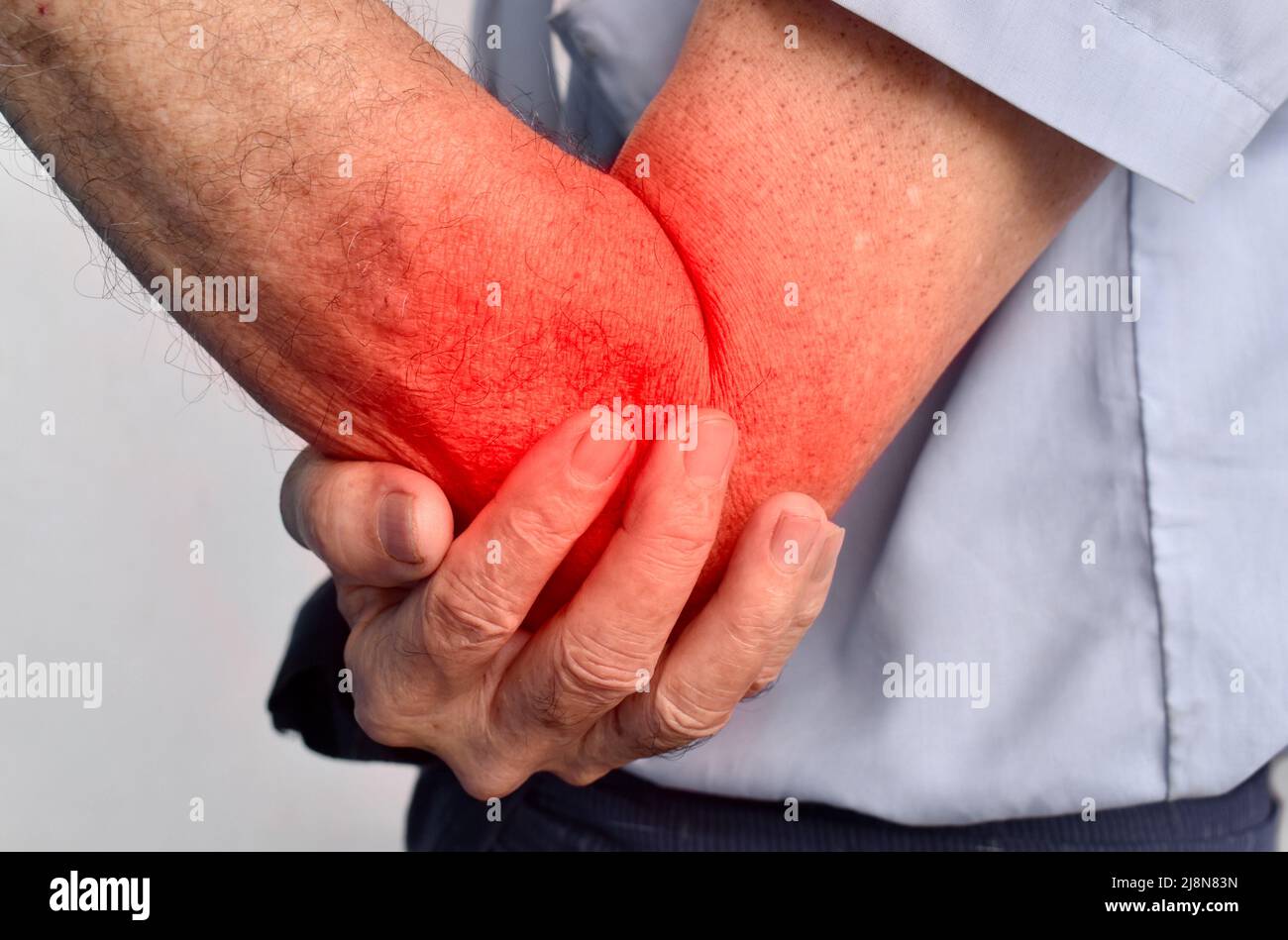 Pain in the elbow joint of Southeast Asian elder man. Concept of elbow