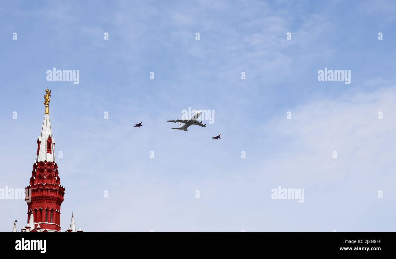 Moscow, Russia, May 2022: IL-80 air control center also called the Doomsday Plane is accompanied by two Mig-29 fighters. Aircrafts participating in th Stock Photo
