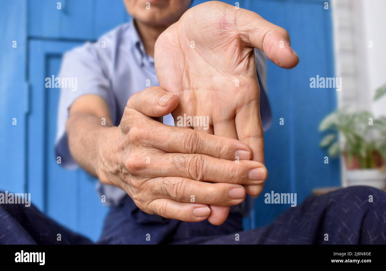 Strengthening exercise for arm muscles of Asian elder male patient with