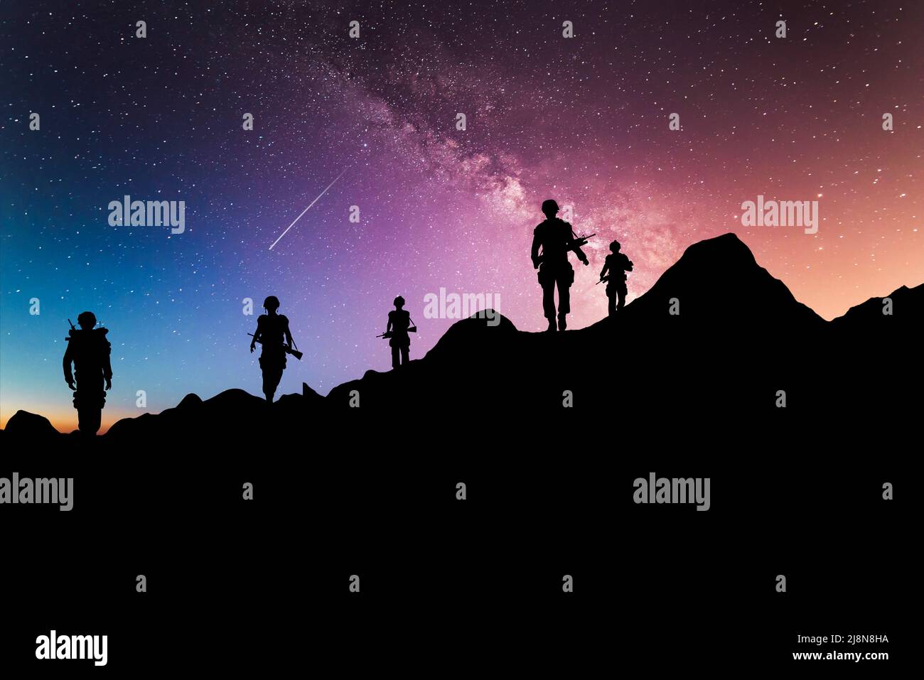 Night time long exposure landscape photography. Soldiers standing on a high place looking amazed at the Milky Way, composite photo Stock Photo