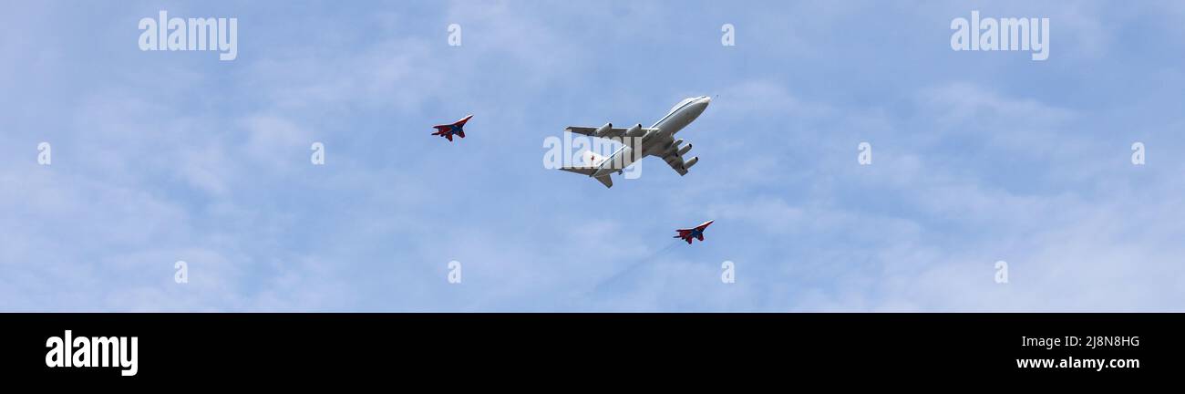 Moscow, Russia, May 2022: Banner with IL-80 air control center also called the Doomsday Plane is accompanied by two Mig-29 fighters. Aircrafts partici Stock Photo