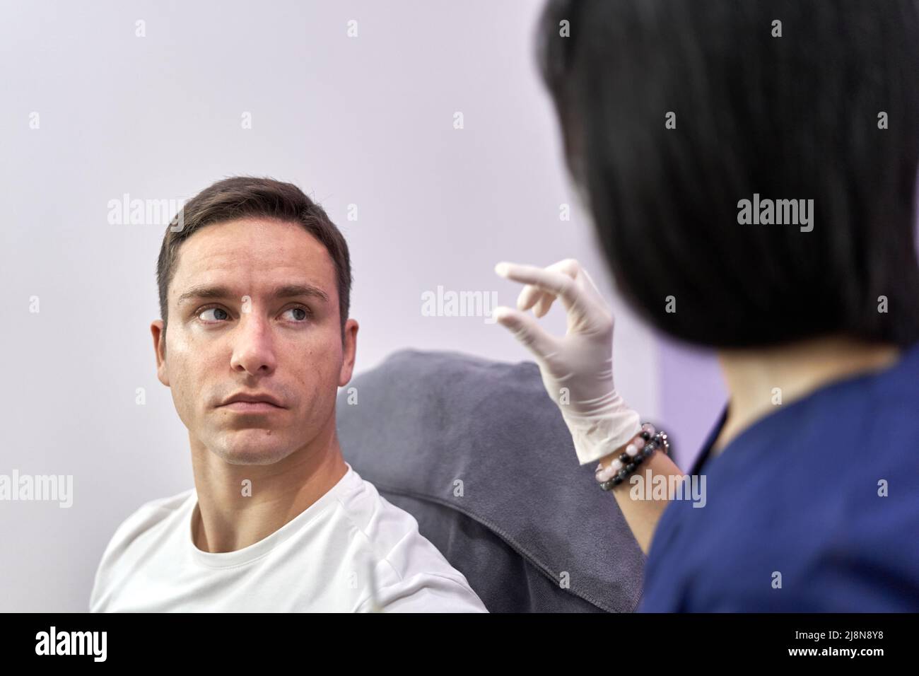 Doctor explaining to a patient while gesturing at a unit of measure Stock Photo