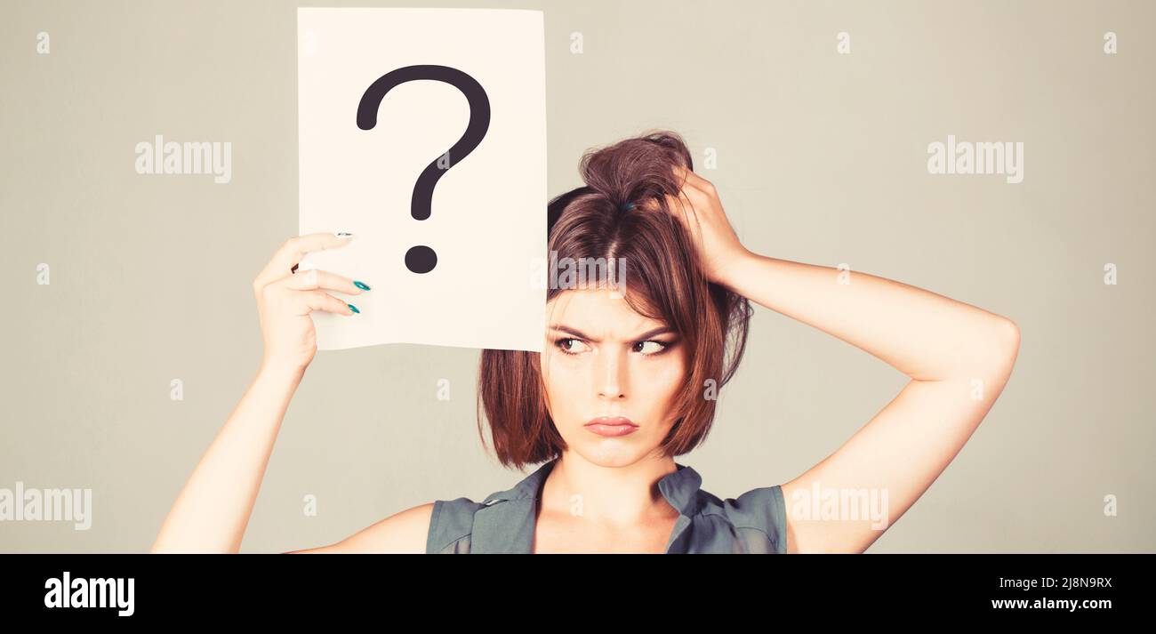 Thinking woman. Concept - challenging issue, looking for the answer. Isolated girl. Woman with doubtful expression and question marks. Question mark Stock Photo