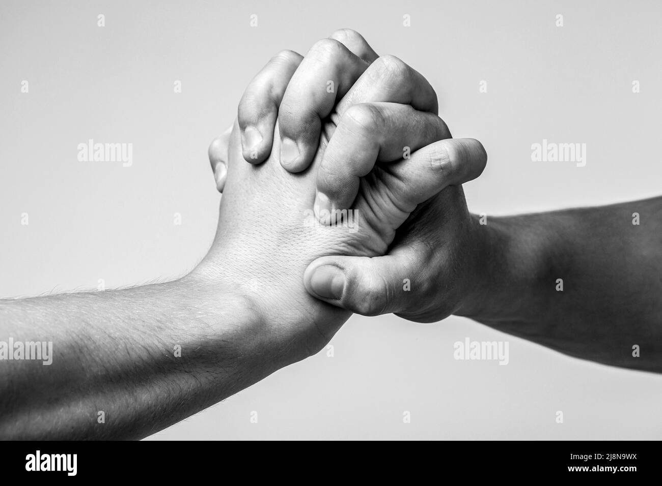 Male hand united in handshake. Man help hands, guardianship, protection