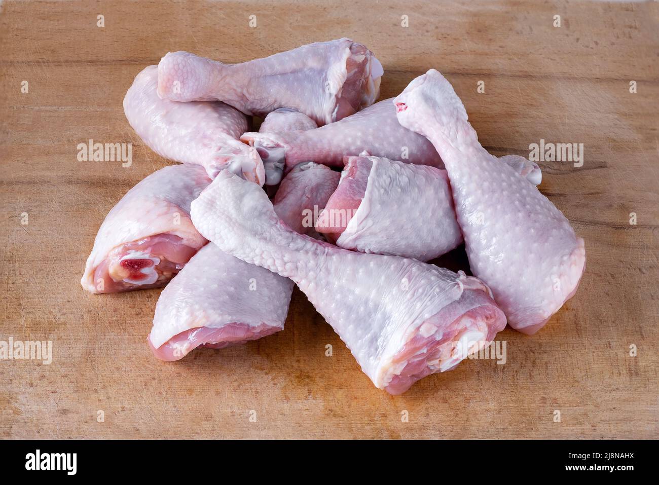 fresh uncooked chicken drumsticks laid out in a heap Stock Photo Alamy